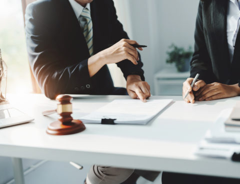 Product Liability In Class Action Lawsuits - Law, Consultation, Agreement, Contract, Attorney or Lawyer holding a pen is consulting with a client to explain the pattern of answering questions before going to court to decide a lawsuit.