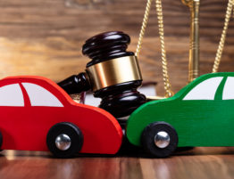 Steps To Take After A Car Accident - Two Green And Red Wooden Cars