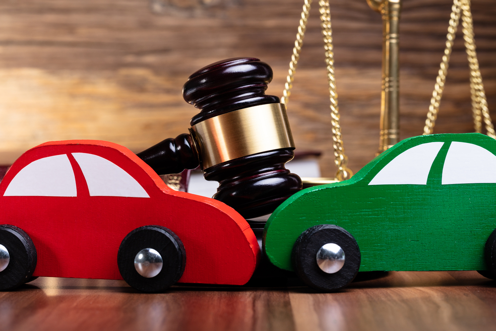 Steps To Take After A Car Accident - Two Green And Red Wooden Cars