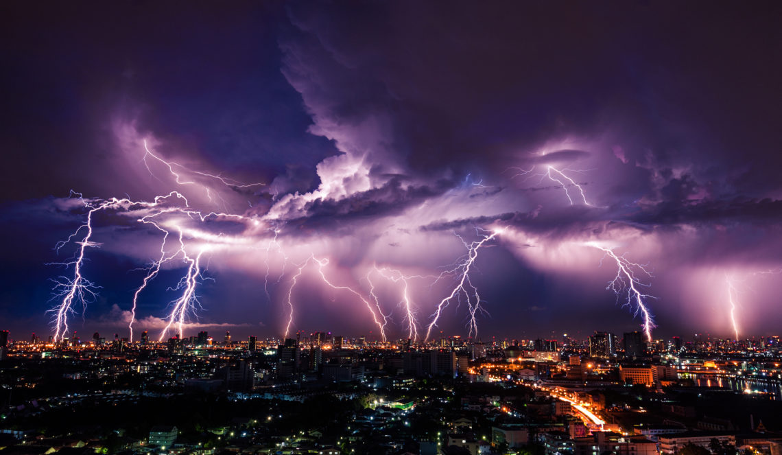 How To Drive In A Thunderstorm - Lightning storm over city in purple light