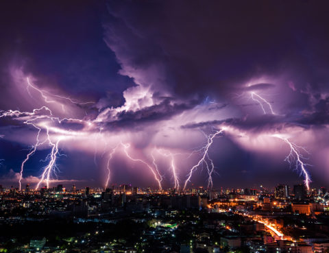 How To Drive In A Thunderstorm - Lightning storm over city in purple light