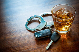 DWI Attorney DC - Whiskey with car keys and handcuffs concept for drinking and driving